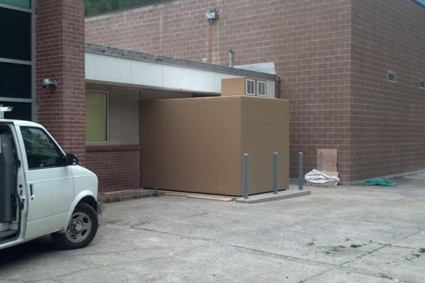 Tan walk-in freezer cooler at the back of a the Kellogg brick building